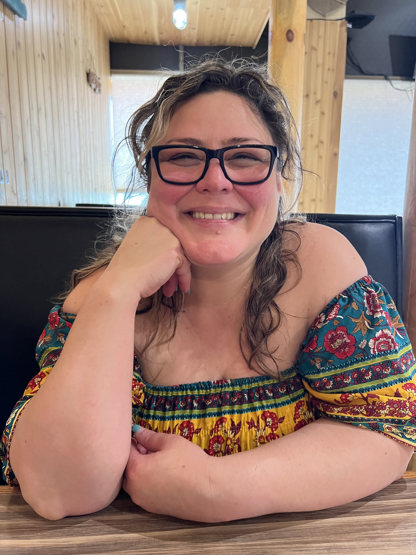 Fayemarie smiling in a floral off-shoulder top