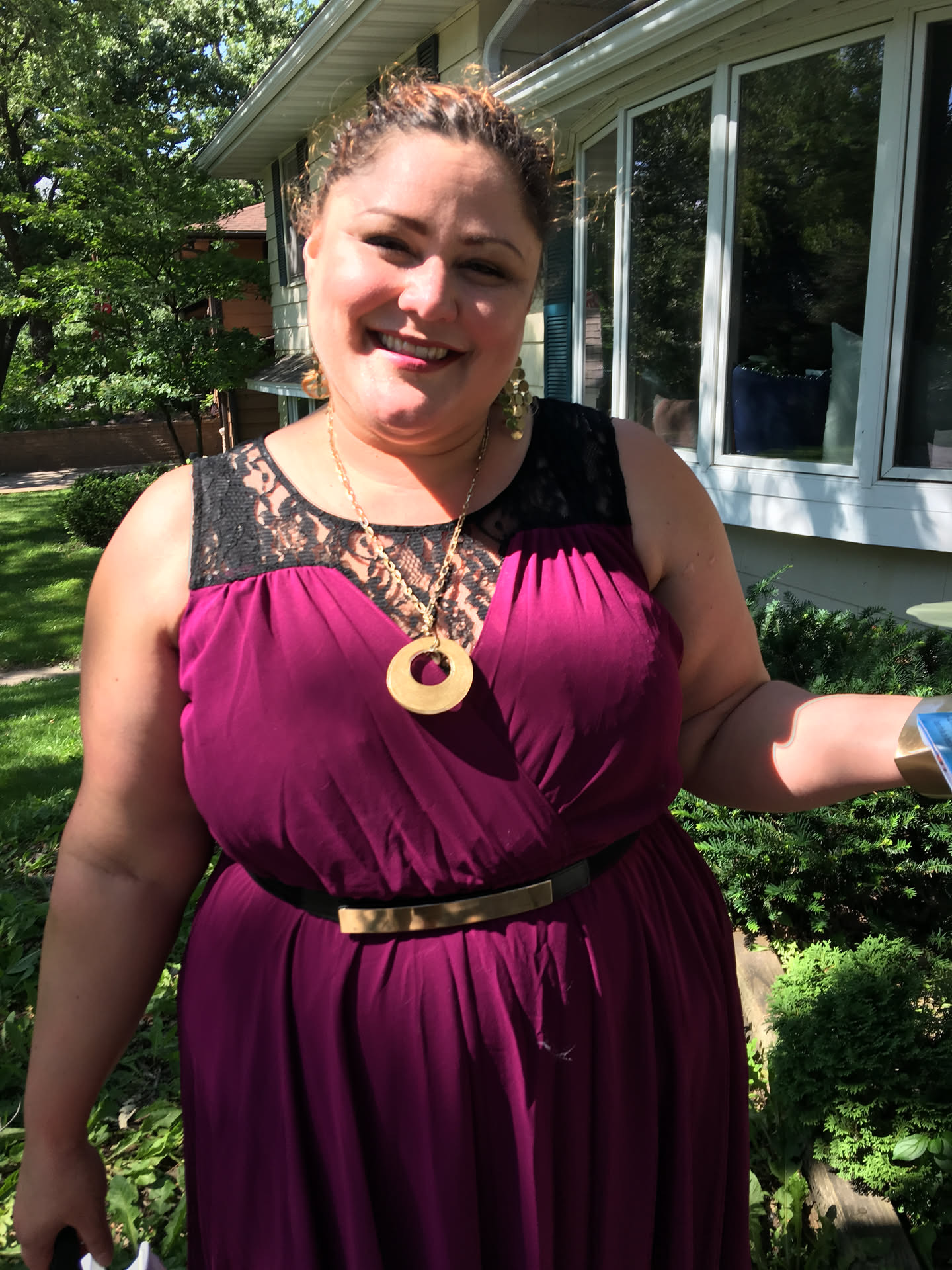 Fayemarie in a magenta dress in a garden